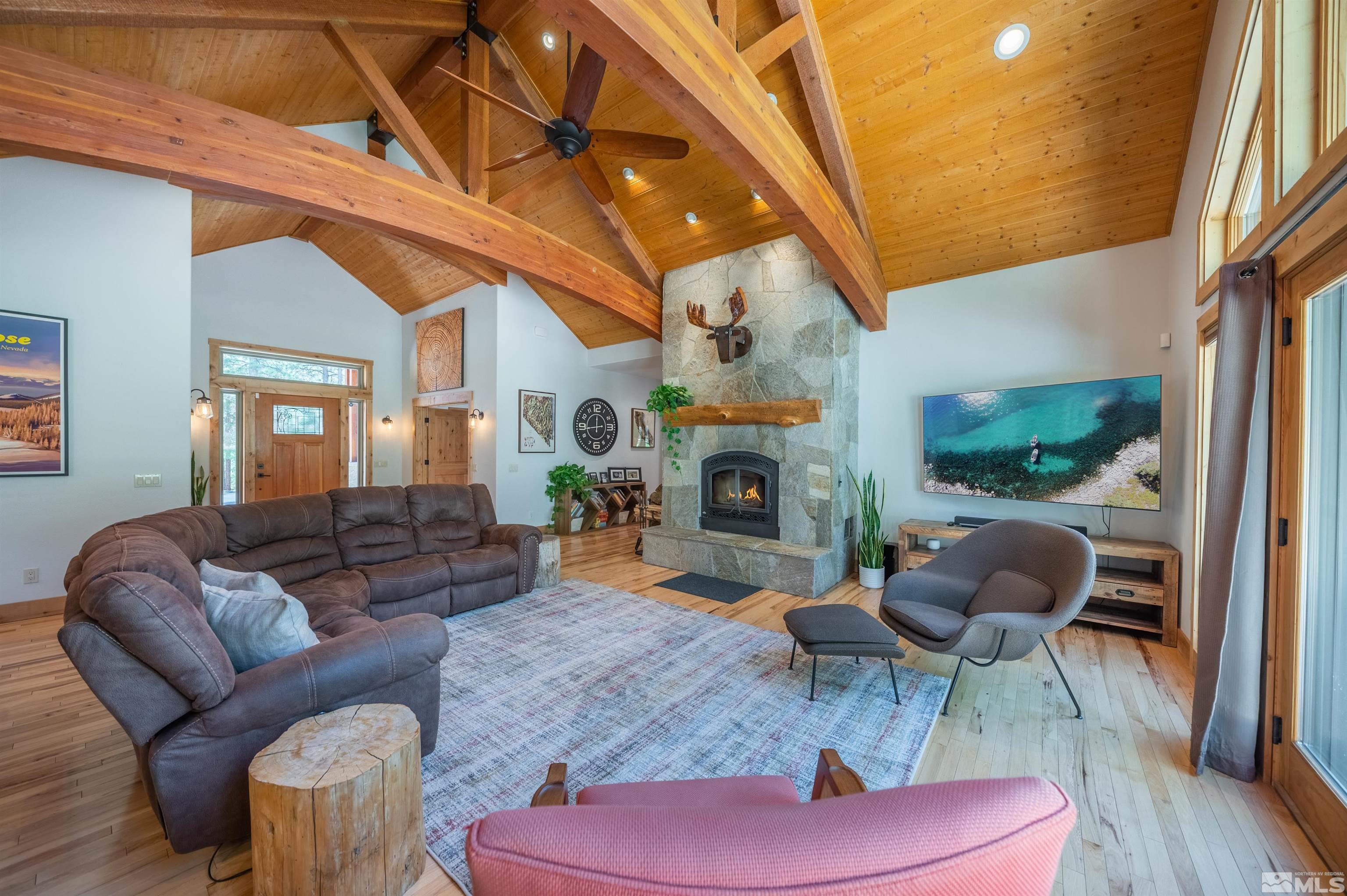 500 Yellow Pine Road Reno, NV 89511 - Photo 10 of 40 a living room with furniture a fireplace and a large window