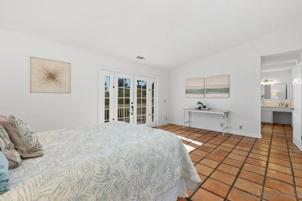 a large bedroom with a bed and a window