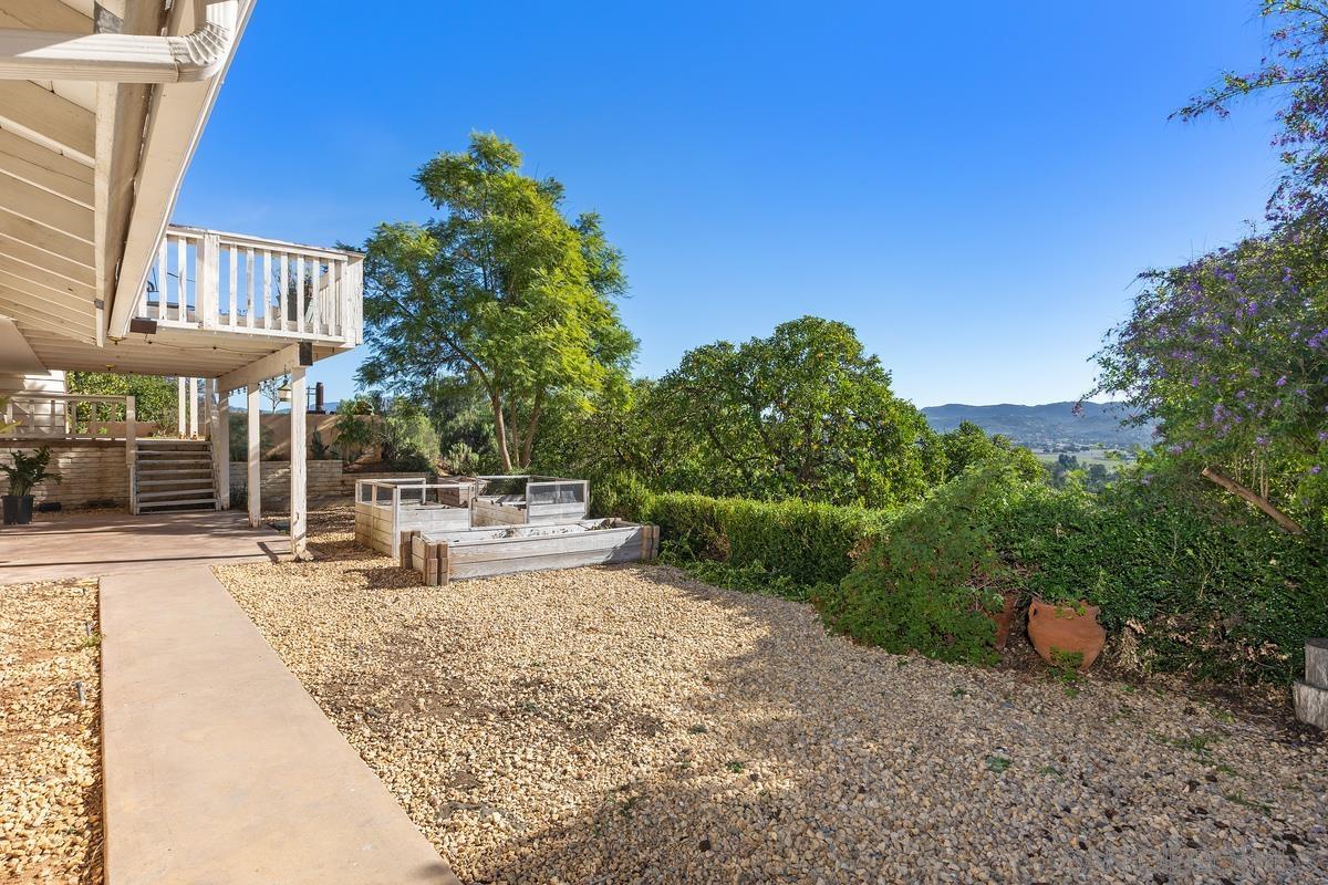 13747 Little Pond Road Valley Center, CA 92082 - Photo 27 of 39 a view of a patio with table and chairs under an umbrella