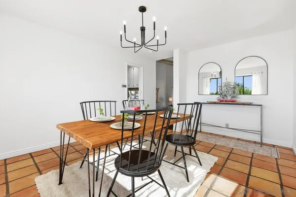 a view of a dining room with furniture and a chandelier