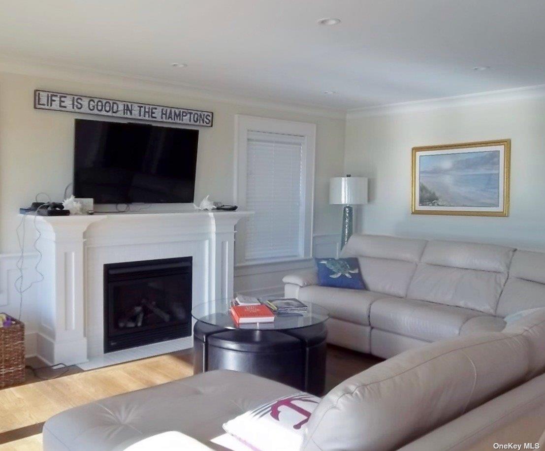 493 Dune Road Westhampton Beach, NY 11978 - Photo 3 of 11 a living room with furniture and a fireplace