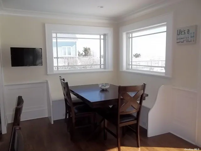 a view of a dining room with furniture and a window