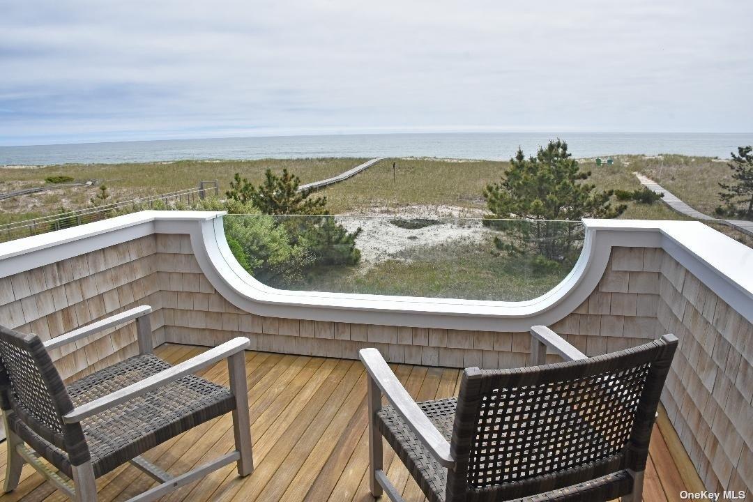 493 Dune Road Westhampton Beach, NY 11978 - Photo 6 of 11 a view of a balcony with chair and city view