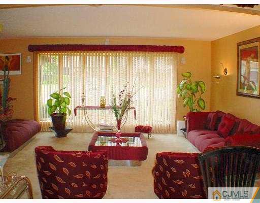 114 South Cliff Road Colonia, NJ 07067 - Photo 2 of 10 a bedroom with a bed a couch and potted plant
