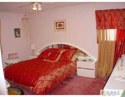 114 South Cliff Road Colonia, NJ 07067 - Photo 8 of 10 a bedroom with a bed and a window