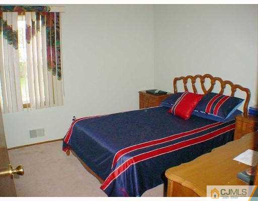 114 South Cliff Road Colonia, NJ 07067 - Photo 9 of 10 a bedroom with a bed and window