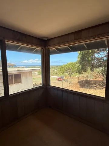 a view of an empty room and a window