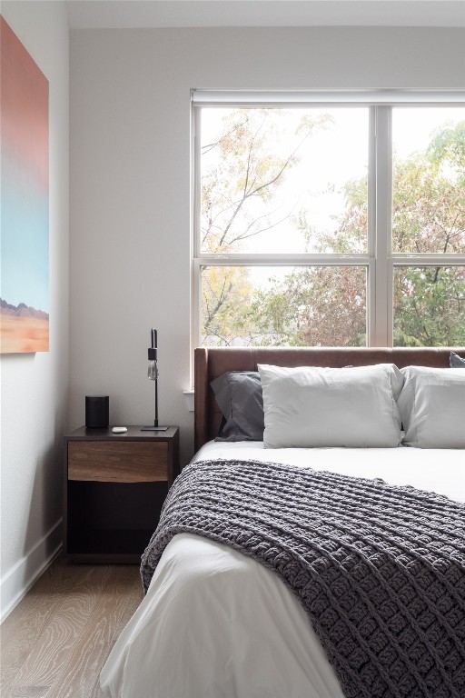 2906 Webberville Road, Unit 2 Austin, TX 78702 - Photo 13 of 21 a bedroom with a bed and a large window