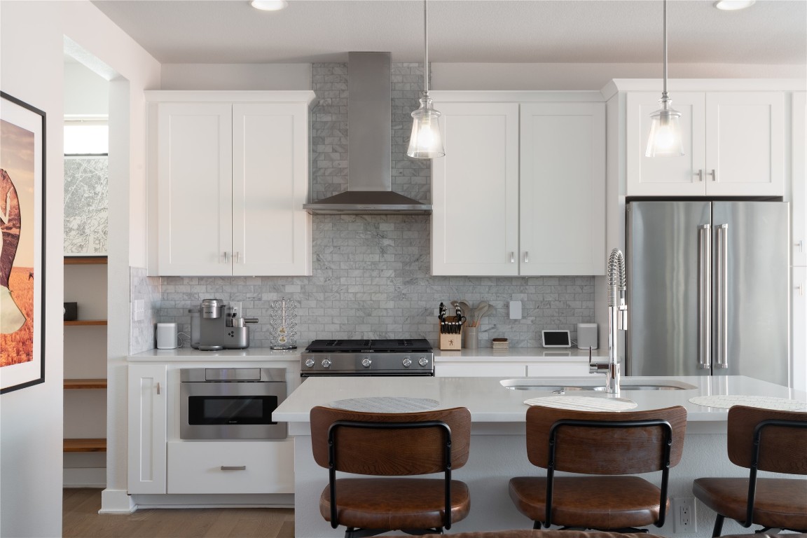 2906 Webberville Road, Unit 2 Austin, TX 78702 - Photo 4 of 21 a kitchen with white cabinets and white appliances
