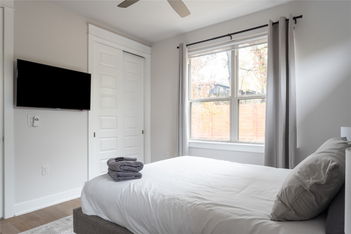 2906 Webberville Road, Unit 2 Austin, TX 78702 - Photo 8 of 21 a bedroom with a bed and a flat screen tv