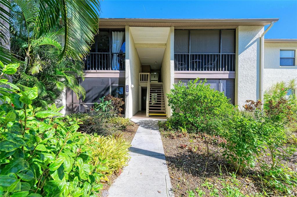 756 White Pine Tree Road, Unit 210 Venice, FL 34285 - Photo 1 of 55 front view of a house with a yard