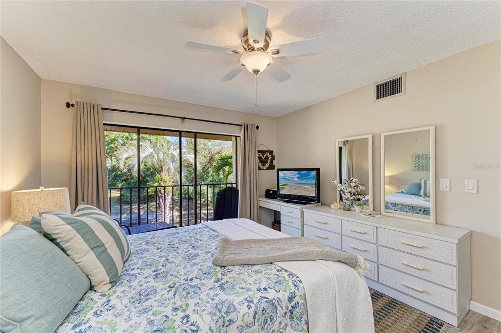 756 White Pine Tree Road, Unit 210 Venice, FL 34285 - Photo 16 of 55 a bedroom with a large bed and a flat tv screen