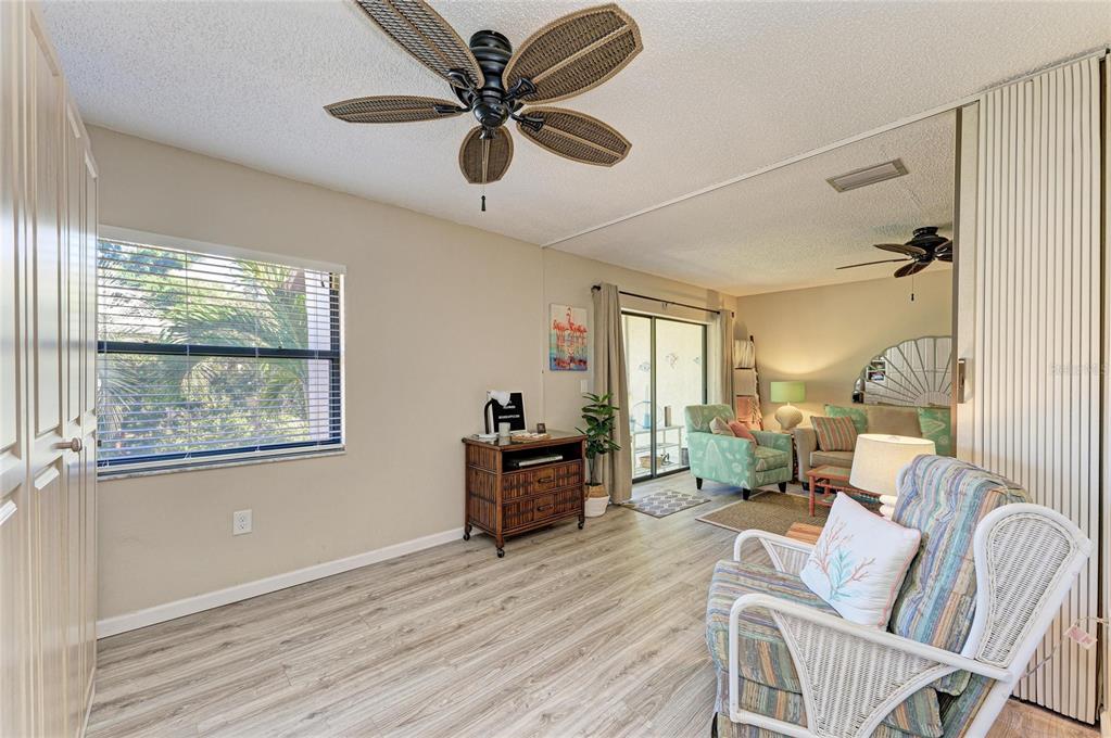756 White Pine Tree Road, Unit 210 Venice, FL 34285 - Photo 22 of 55 a living room with furniture and a wooden floor