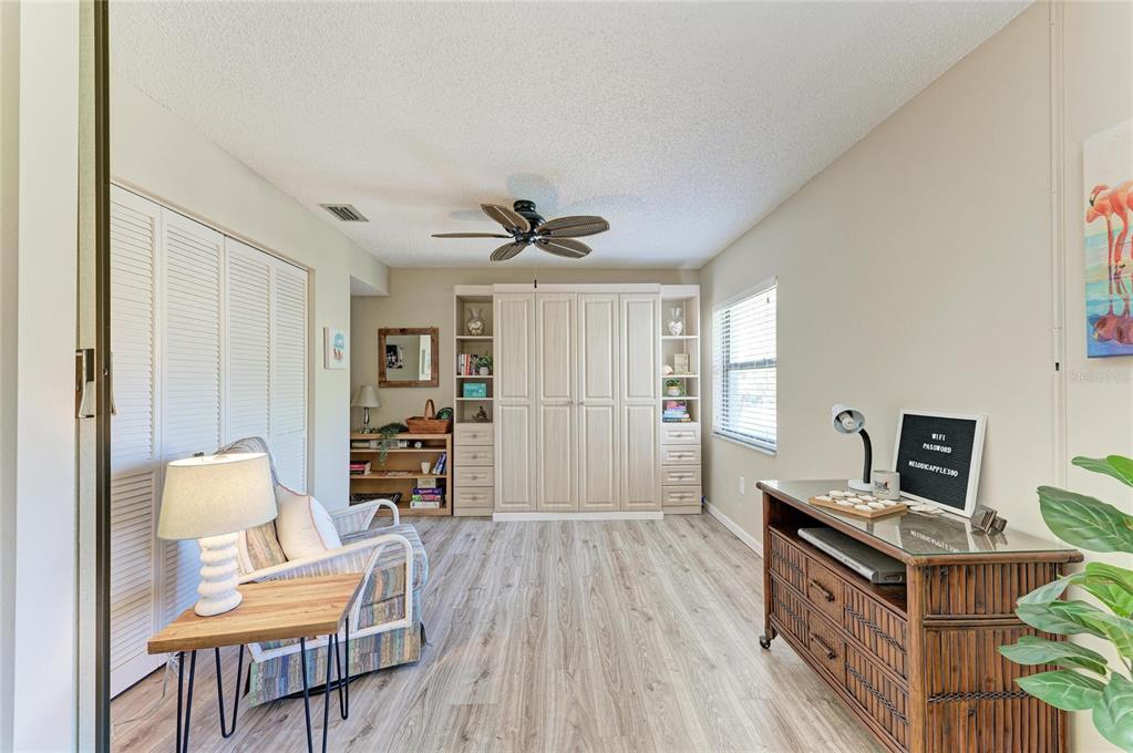 756 White Pine Tree Road, Unit 210 Venice, FL 34285 - Photo 24 of 55 a living room with furniture and a wooden floor