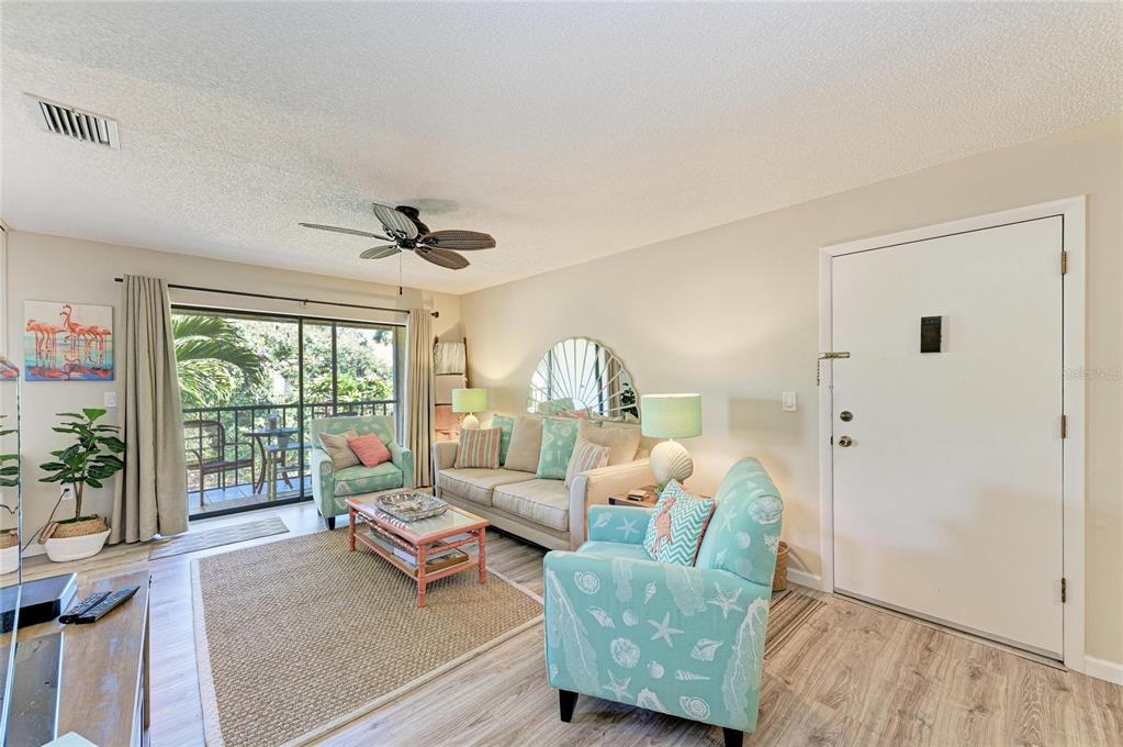 756 White Pine Tree Road, Unit 210 Venice, FL 34285 - Photo 4 of 55 a living room with furniture and a large window