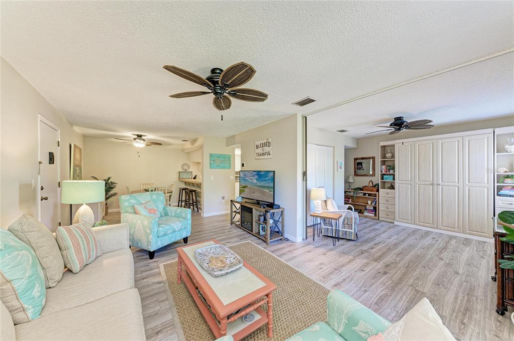 756 White Pine Tree Road, Unit 210 Venice, FL 34285 - Photo 5 of 55 a living room with furniture and a fireplace
