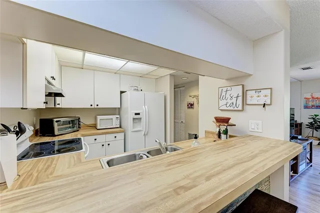 a kitchen with a stove a sink and a refrigerator