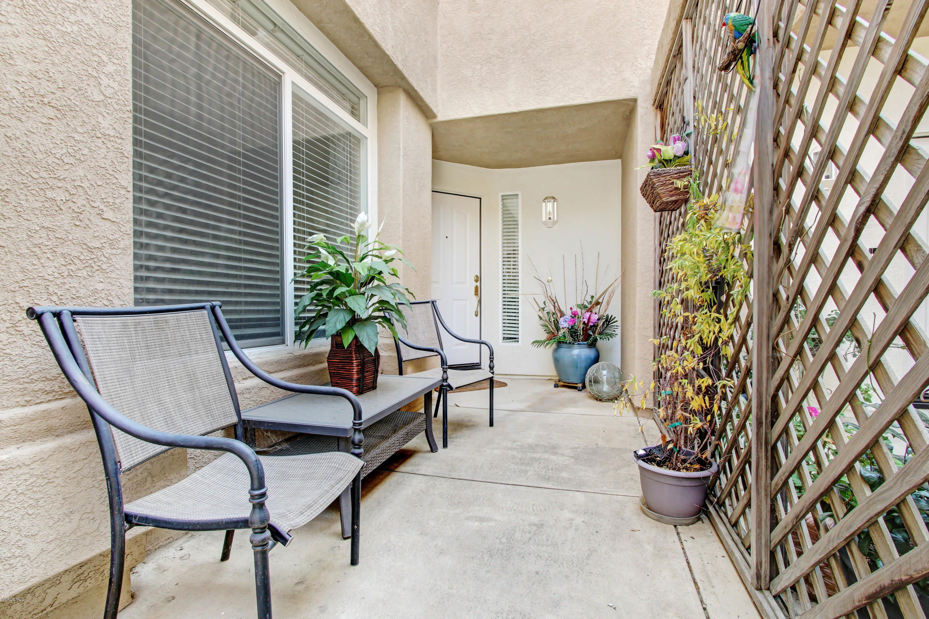 697 Lariate Lane, Unit A Simi Valley, CA 93065 - Photo 2 of 26 a view of a porch with chairs and potted plants