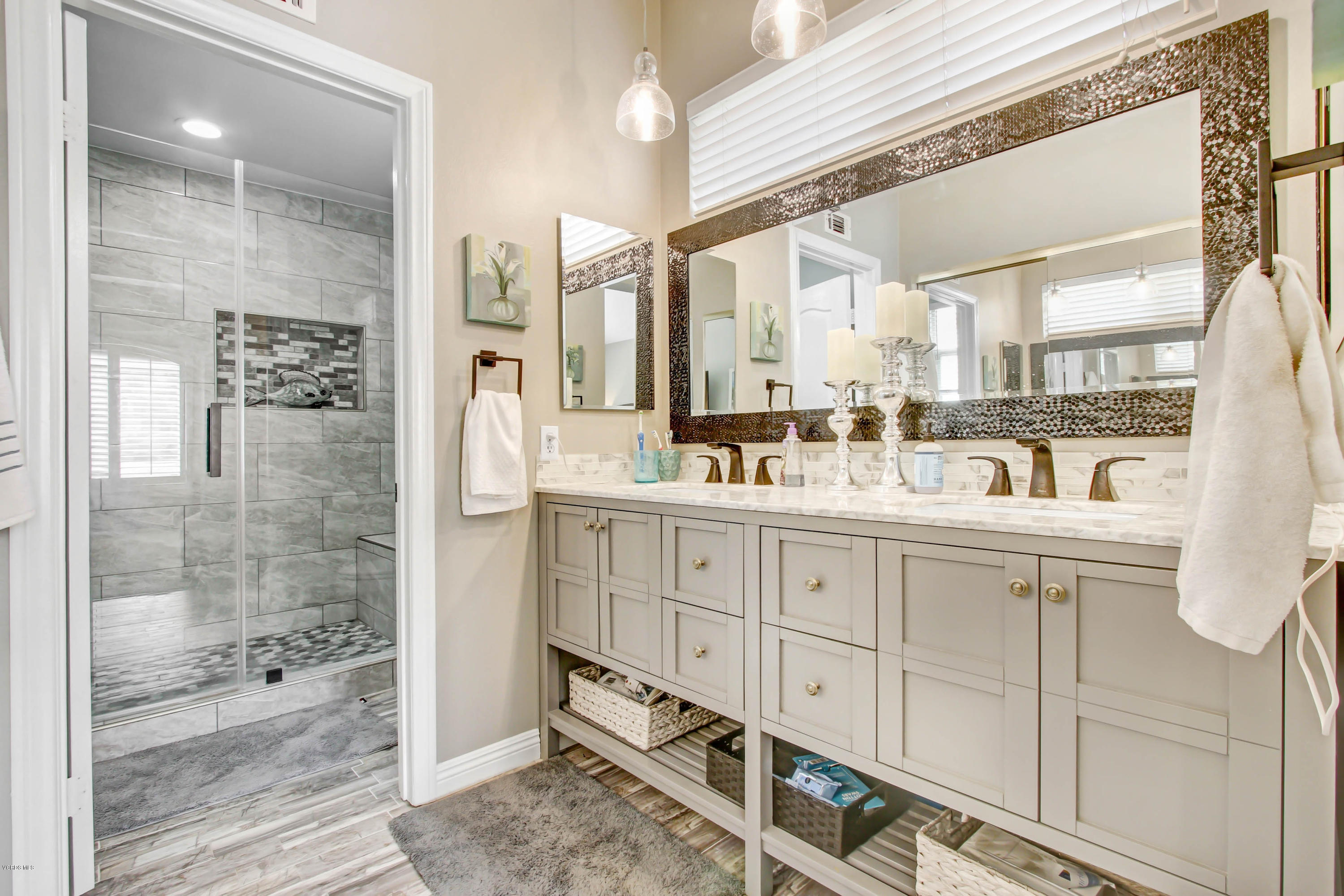 697 Lariate Lane, Unit A Simi Valley, CA 93065 - Photo 14 of 26 a bathroom with a double vanity sink a mirror and a shower