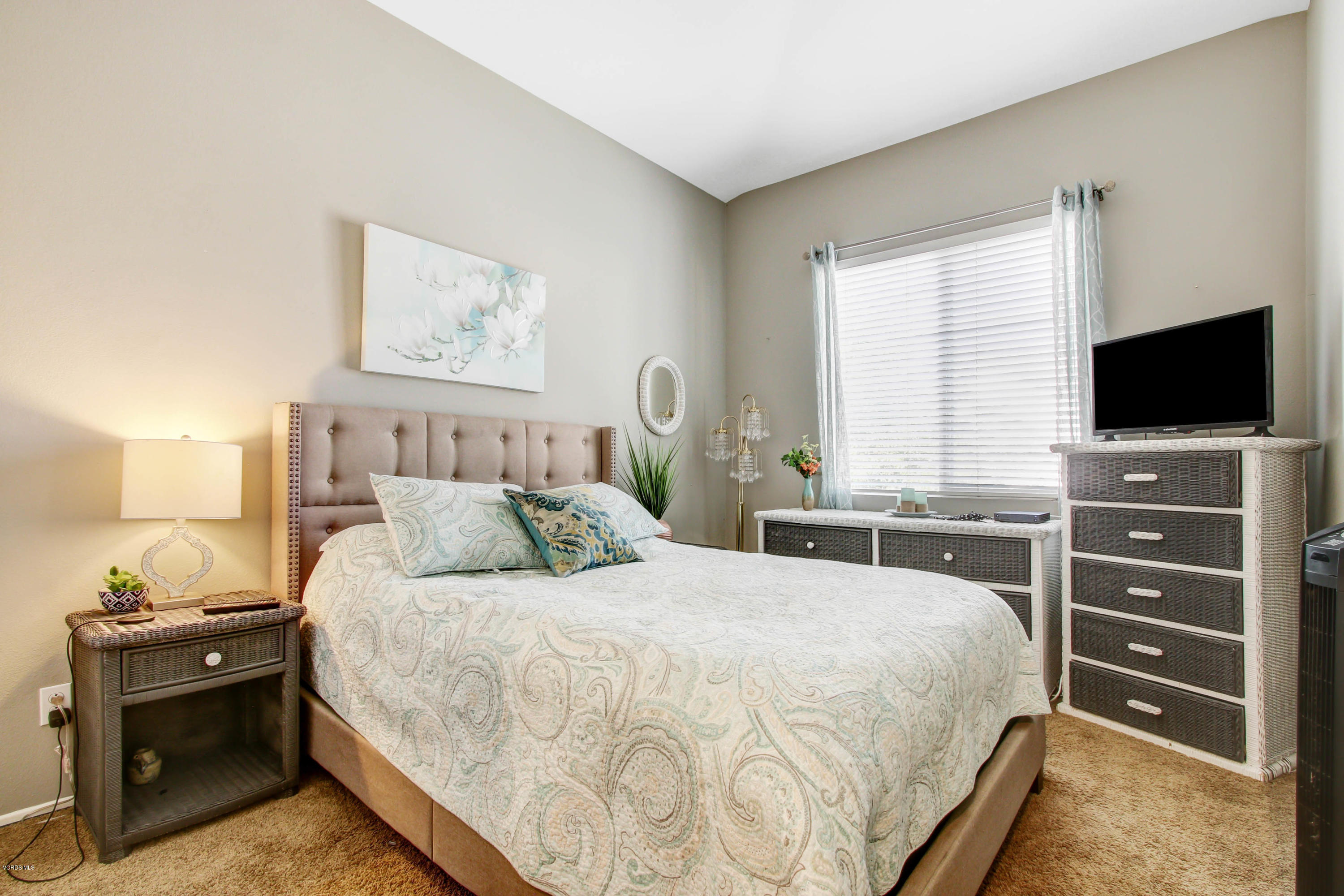 697 Lariate Lane, Unit A Simi Valley, CA 93065 - Photo 19 of 26 a bedroom with a bed and a flat tv screen on a dresser