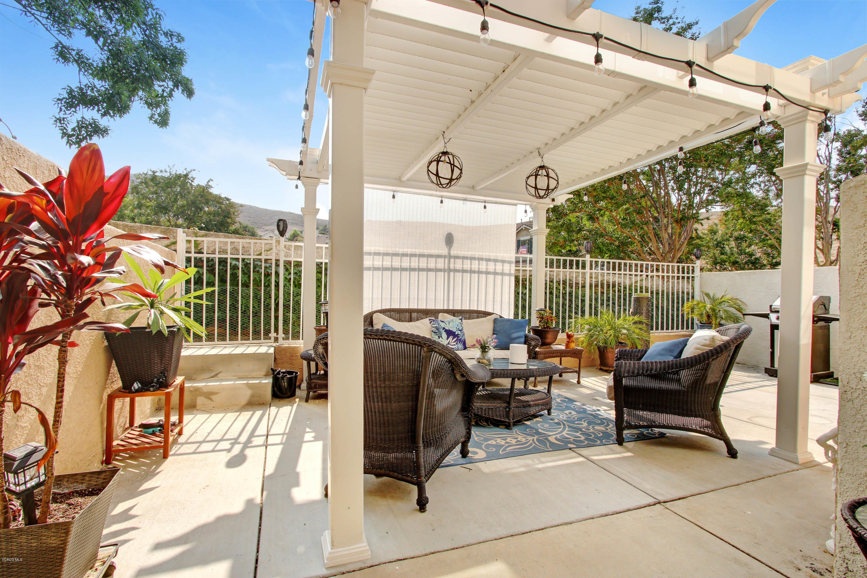697 Lariate Lane, Unit A Simi Valley, CA 93065 - Photo 20 of 26 a view of a patio with a table chairs and a potted plant