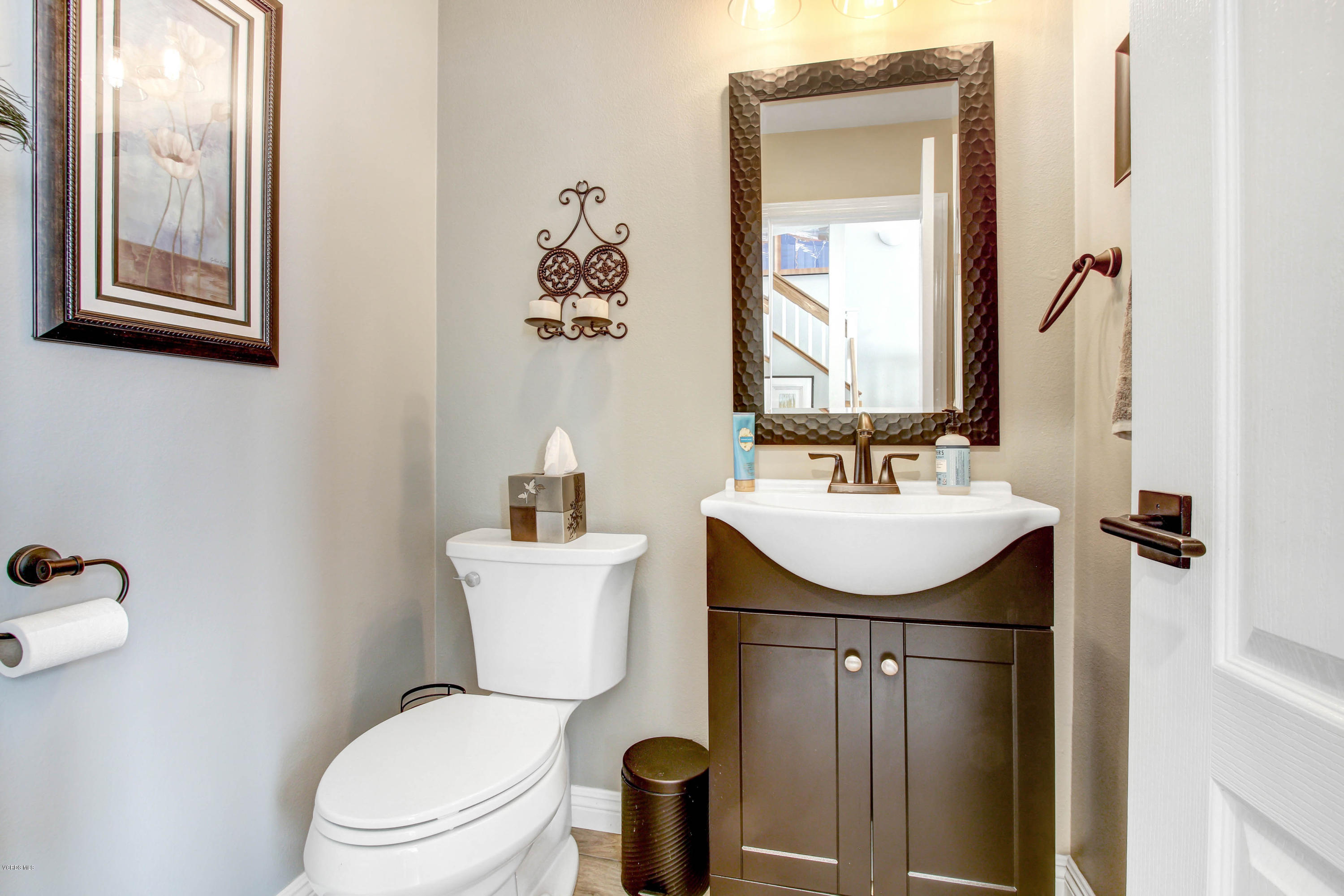 697 Lariate Lane, Unit A Simi Valley, CA 93065 - Photo 4 of 26 a bathroom with a toilet sink and mirror