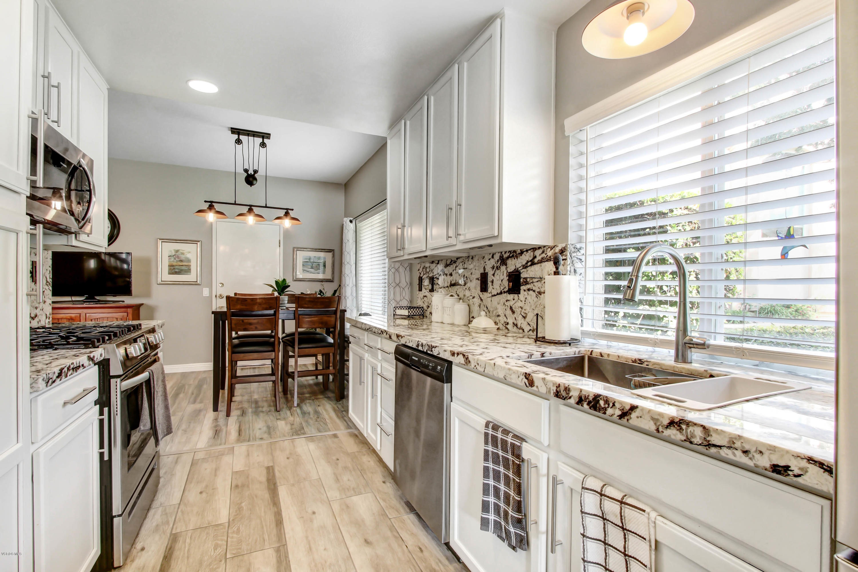 697 Lariate Lane, Unit A Simi Valley, CA 93065 - Photo 7 of 26 a kitchen with stainless steel appliances granite countertop a sink stove and refrigerator
