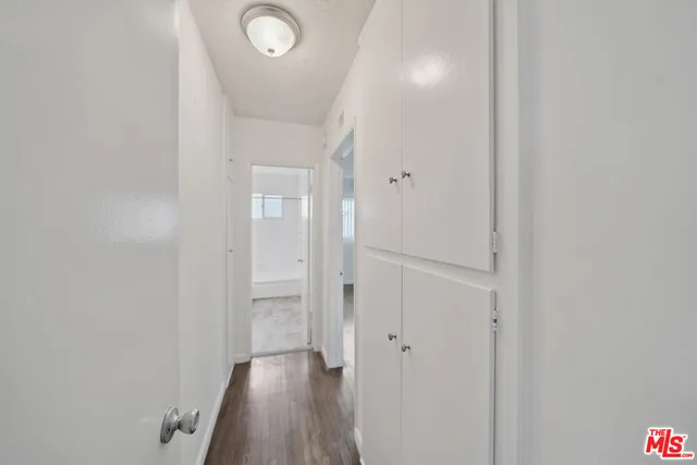 a view of a hallway with wooden floor