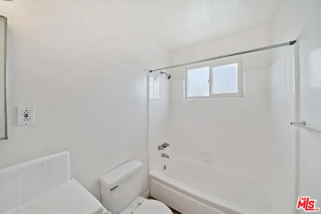 a bathroom with a toilet and a bathtub