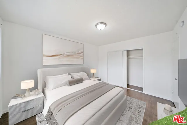 a bedroom with a bed and a painting on the wall