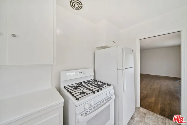 a kitchen with a stove and a refrigerator