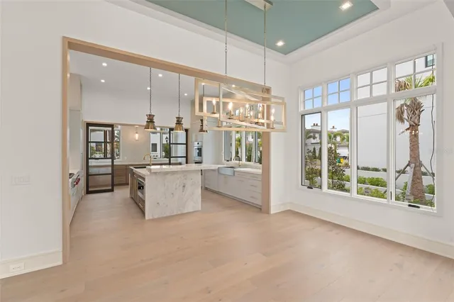 a kitchen with stainless steel appliances granite countertop a sink a stove and a refrigerator