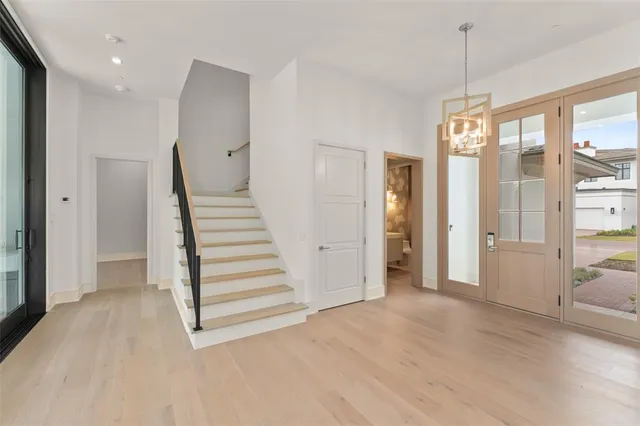 a view of a hallway with stairs and a window