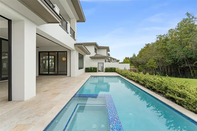 an aerial view of a house with swimming pool garden and patio
