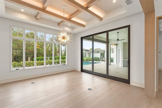 a large kitchen with kitchen island a stove a sink a refrigerator and windows