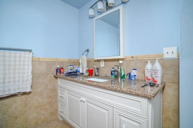 a kitchen with granite countertop a sink and cabinets