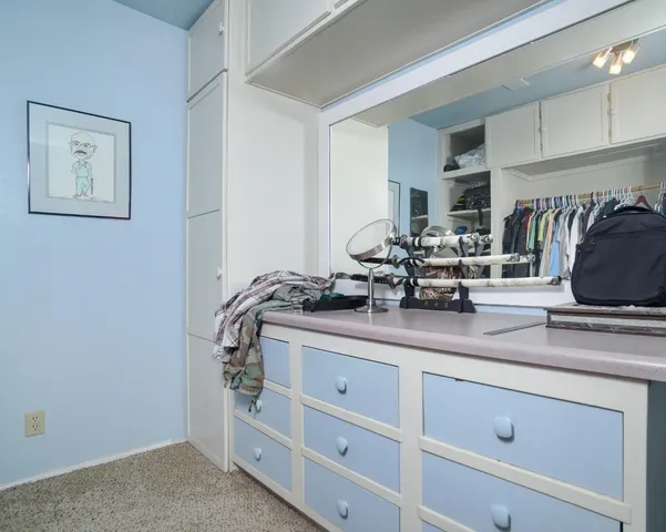 a kitchen with cabinets and chairs