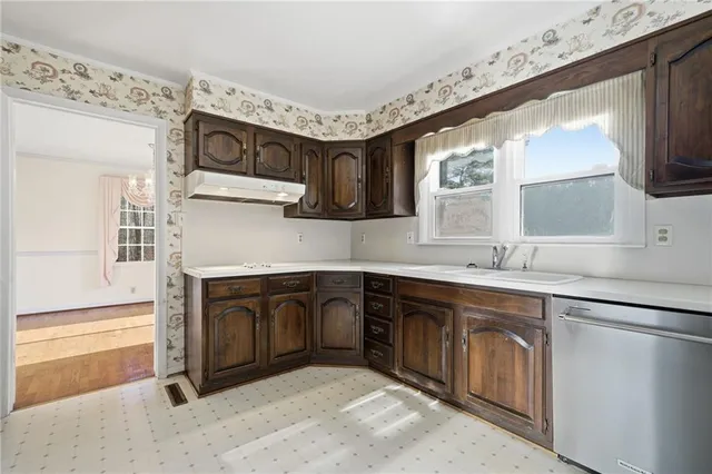 a kitchen with stainless steel appliances granite countertop a sink stove and cabinets