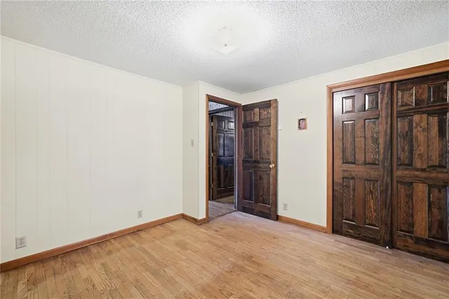 an empty room with closet area