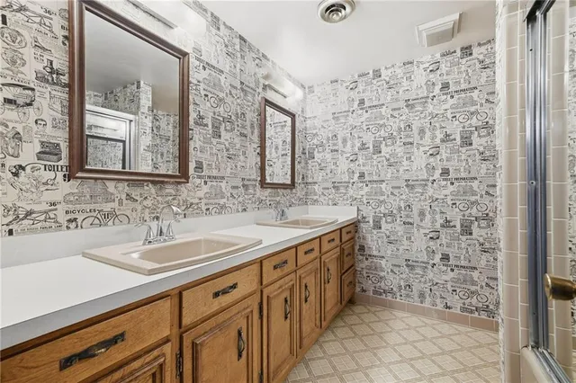 a bathroom with a sink a mirror and a shower