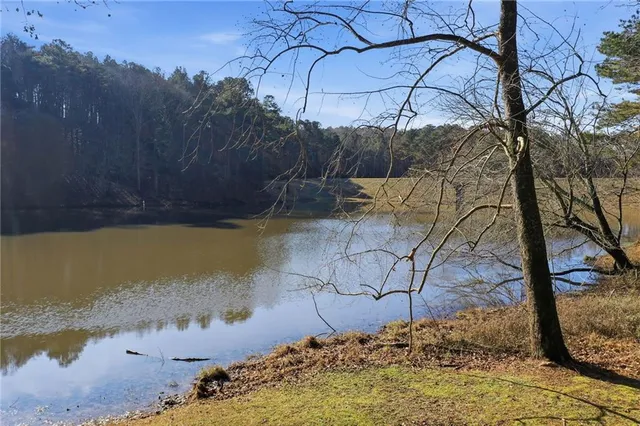 a view of a yard with wooden fence