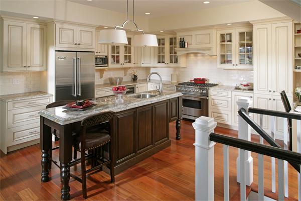 a kitchen with kitchen island a stove a refrigerator and a dining table with cabinets