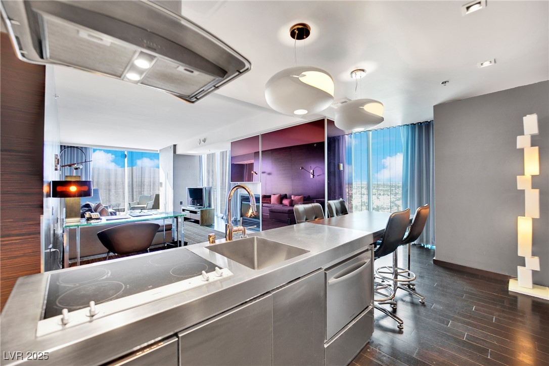 Kitchen featuring black electric cooktop, dark woo
