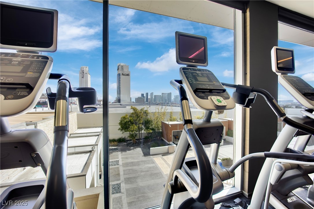 4381 West Flamingo Road, Unit 1901 Las Vegas, NV 89103 - Photo 13 of 18 Workout area with a wall of windows and a city vie