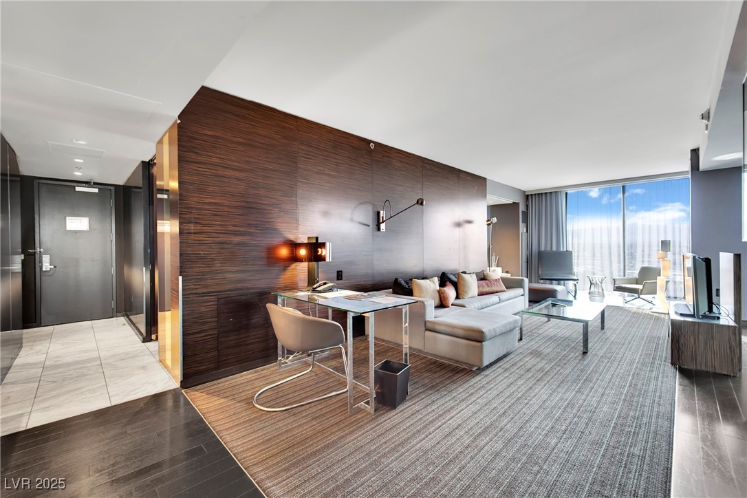 4381 West Flamingo Road, Unit 1901 Las Vegas, NV 89103 - Photo 2 of 18 Living room featuring expansive windows and wood f