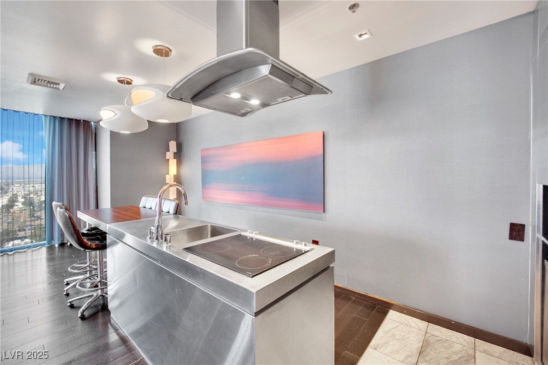 4381 West Flamingo Road, Unit 1901 Las Vegas, NV 89103 - Photo 3 of 18 Kitchen featuring black electric stovetop, stainle