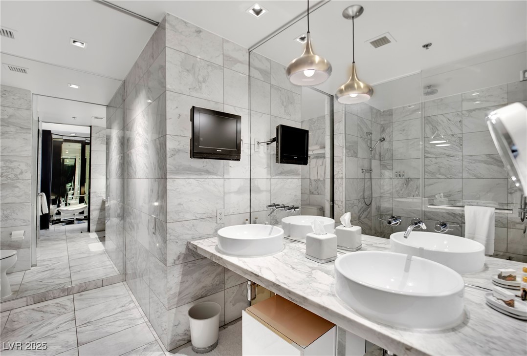 4381 West Flamingo Road, Unit 1901 Las Vegas, NV 89103 - Photo 9 of 18 Full bath with double vanity, marble finish floor,