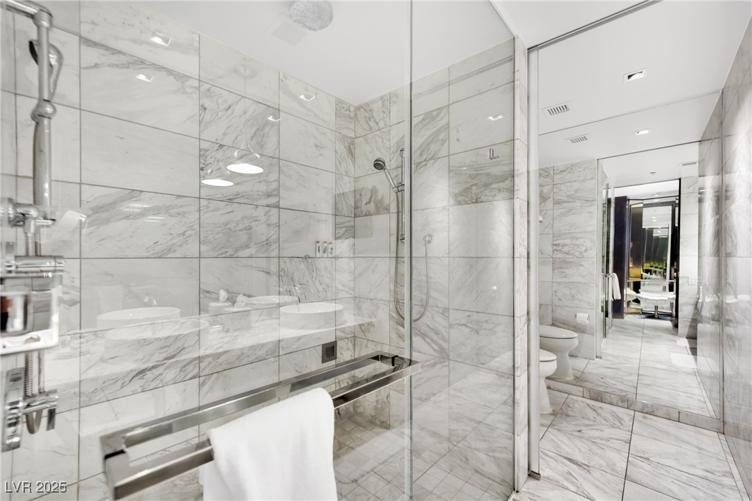 4381 West Flamingo Road, Unit 1901 Las Vegas, NV 89103 - Photo 10 of 18 Full bath with a stall shower, visible vents, toil