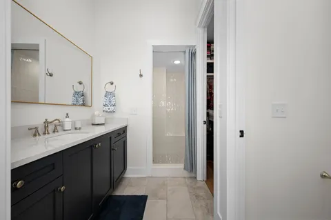a bathroom with a double vanity sink and mirror