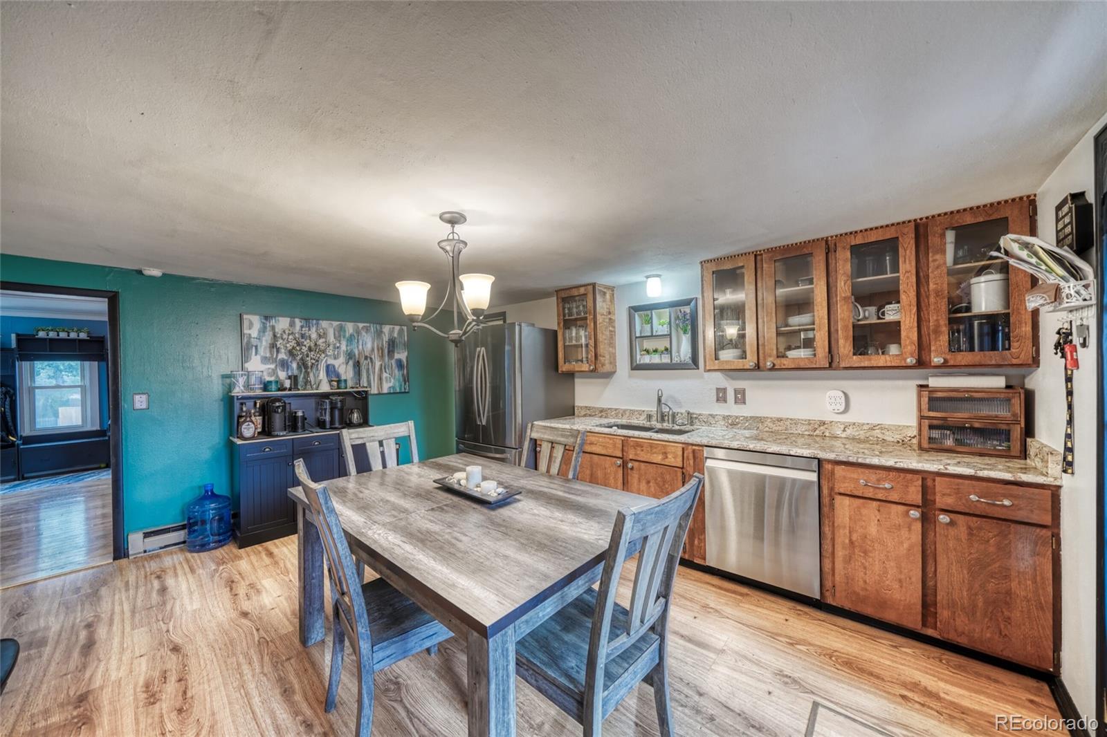 306 Elm Street Leadville, CO 80461 - Photo 14 of 42 a kitchen with a kitchen island wooden cabinets and center island